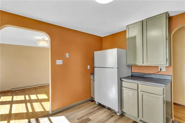 a kitchen with a refrigerator and a window
