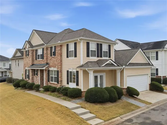 a front view of a house with a yard