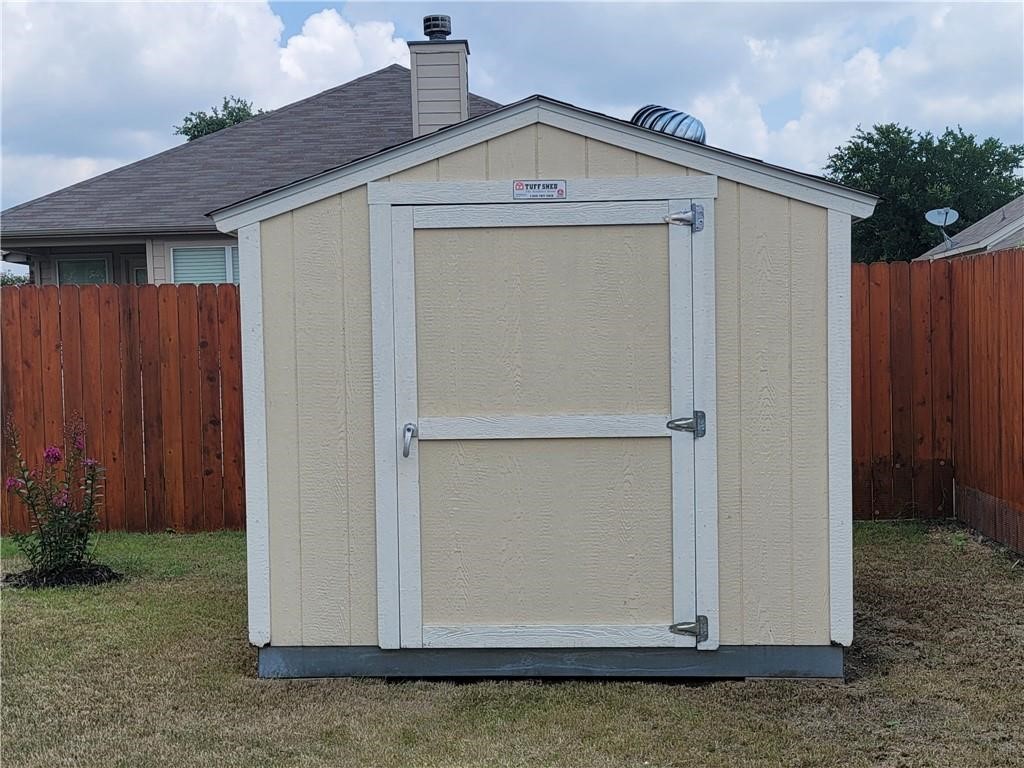 208 Hummingbird Lane Leander, TX 78641 - Photo 21 of 25 A tidy shed with an appealing, functional design stands ready for storage needs.