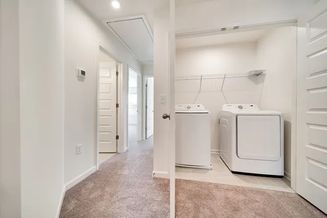 a view of a storage & utility room with a washer dryer