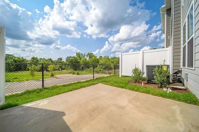 a view of a garden with tall buildings
