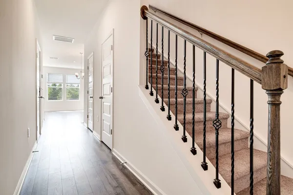 a view of staircase with wooden floor and stairs