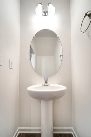 a bathroom with a sink a mirror and vanity