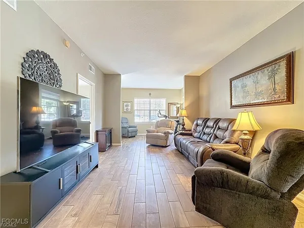 a living room with furniture and a wooden floor