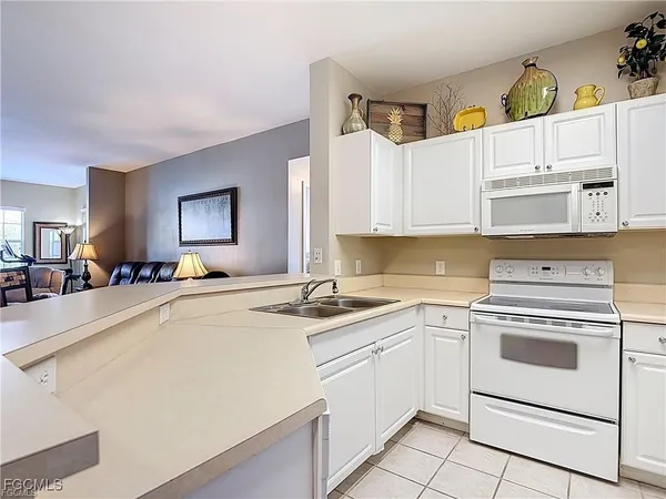 a kitchen with cabinets appliances and a sink