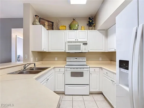 a kitchen with a sink cabinets and window