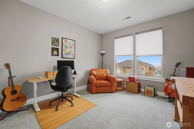 a livingroom with workspace and a window