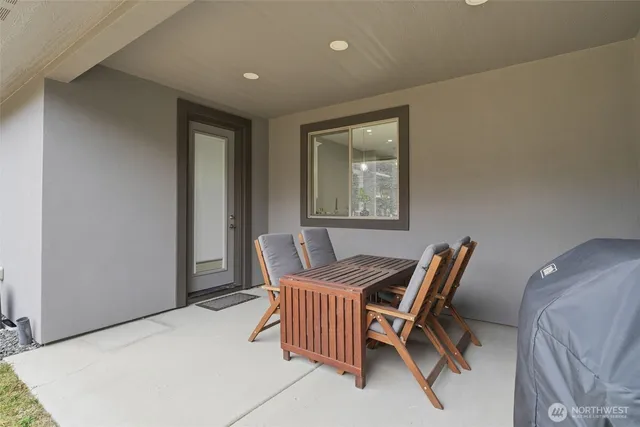 a view of a dining room with furniture and a window