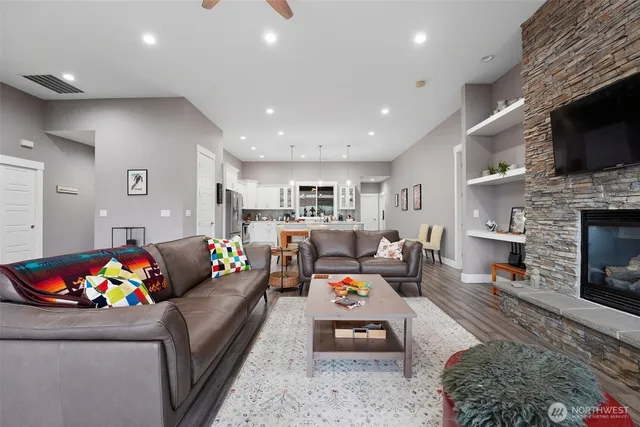 a living room with furniture a flat screen tv and a fireplace