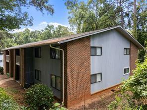 1010 Sandlin Place, Unit E Raleigh, NC 27606 - Photo 2 of 10 a house with a tree in the background
