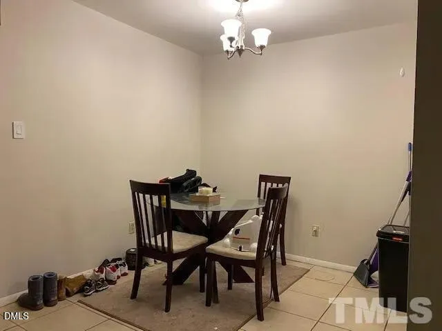 a view of a dining room with furniture and a chandelier fan