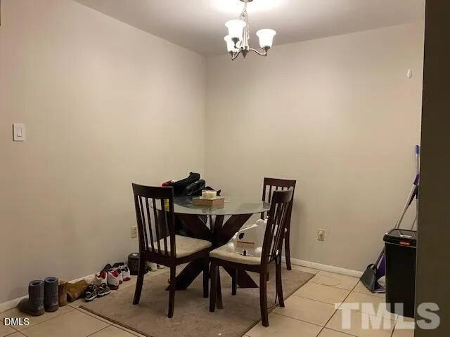 1010 Sandlin Place, Unit E Raleigh, NC 27606 - Photo 5 of 10 a view of a dining room with furniture and a chandelier fan