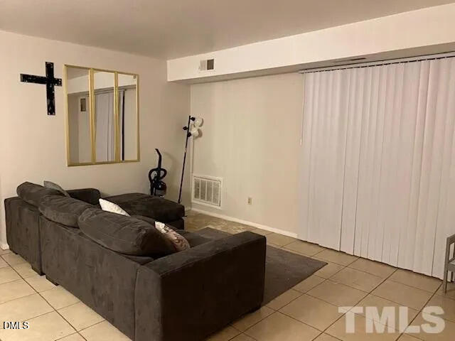 1010 Sandlin Place, Unit E Raleigh, NC 27606 - Photo 6 of 10 a living room with furniture and a window