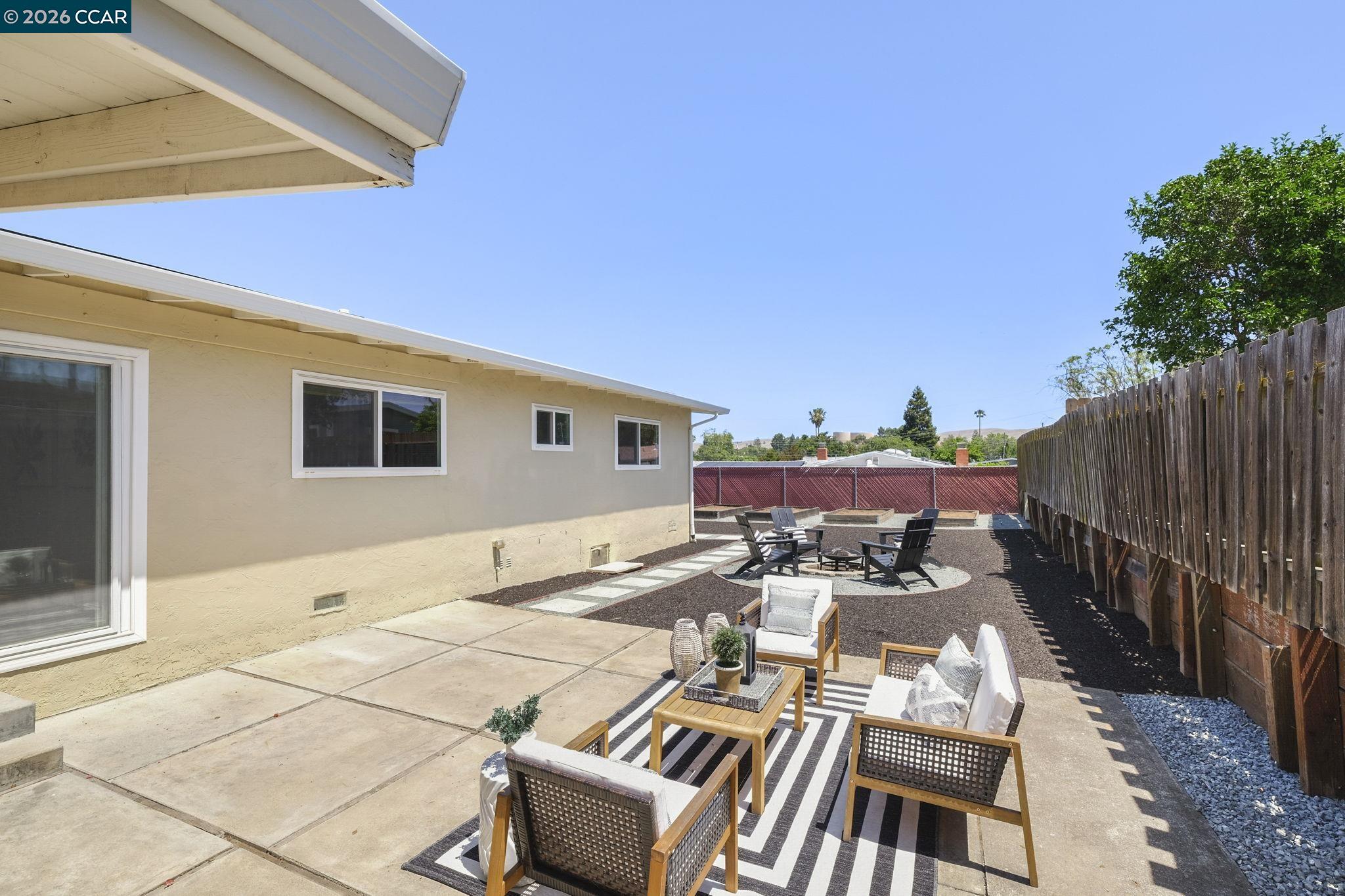 4311 Cowell Road Concord, CA 94521 - Photo 24 of 29 a view of a patio with table and chairs with wooden floor and fence