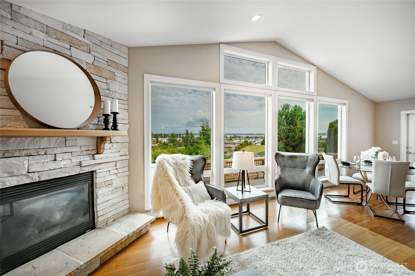 8124 Comox Road Blaine, WA 98230 - Photo 11 of 31 a living room with furniture a fireplace and a floor to ceiling window