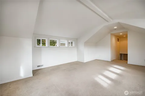 a view of a balcony with wooden floor and fence
