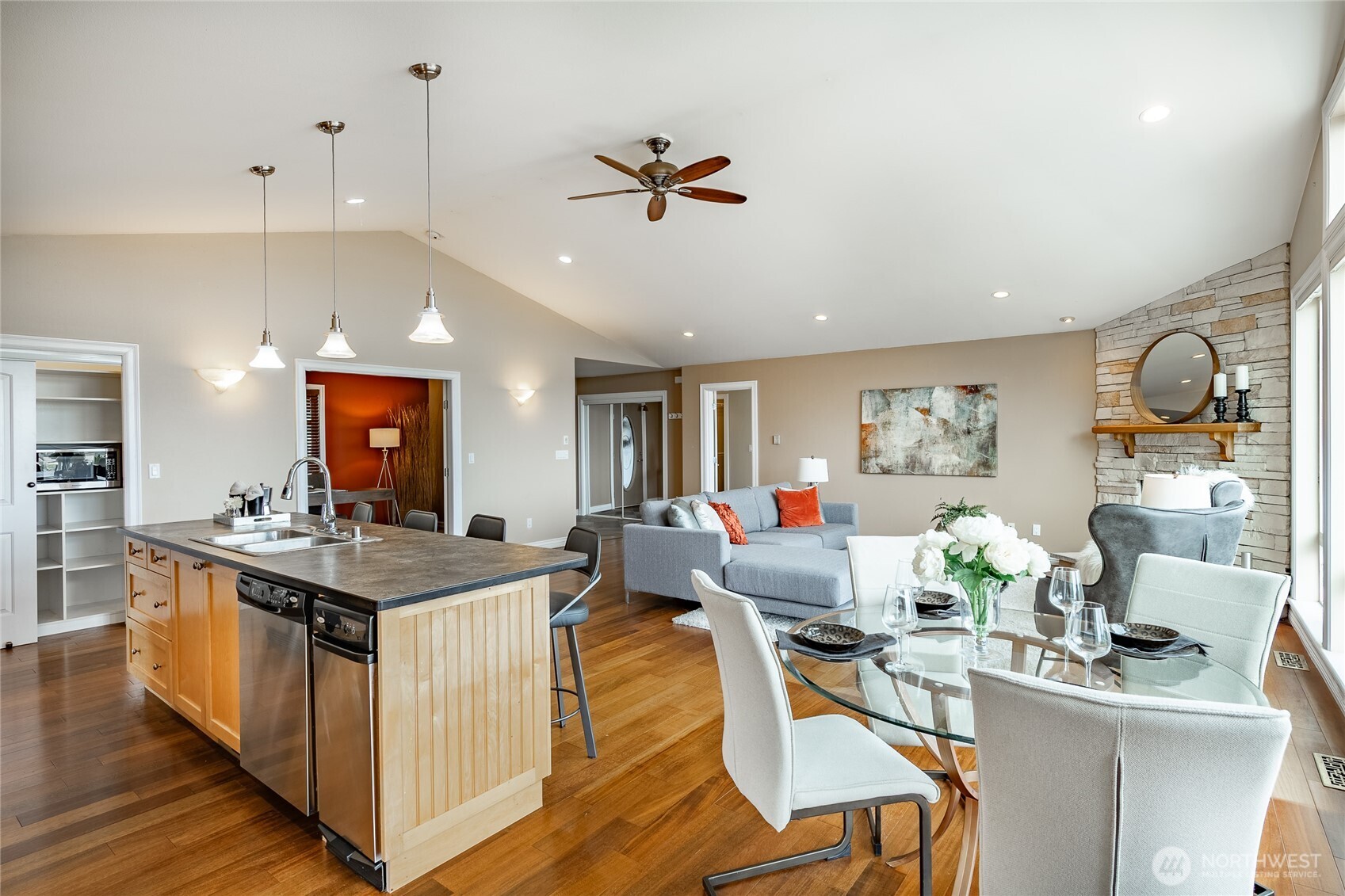 8124 Comox Road Blaine, WA 98230 - Photo 8 of 31 a kitchen with stainless steel appliances granite countertop a stove oven a dining table and chairs with wooden floor