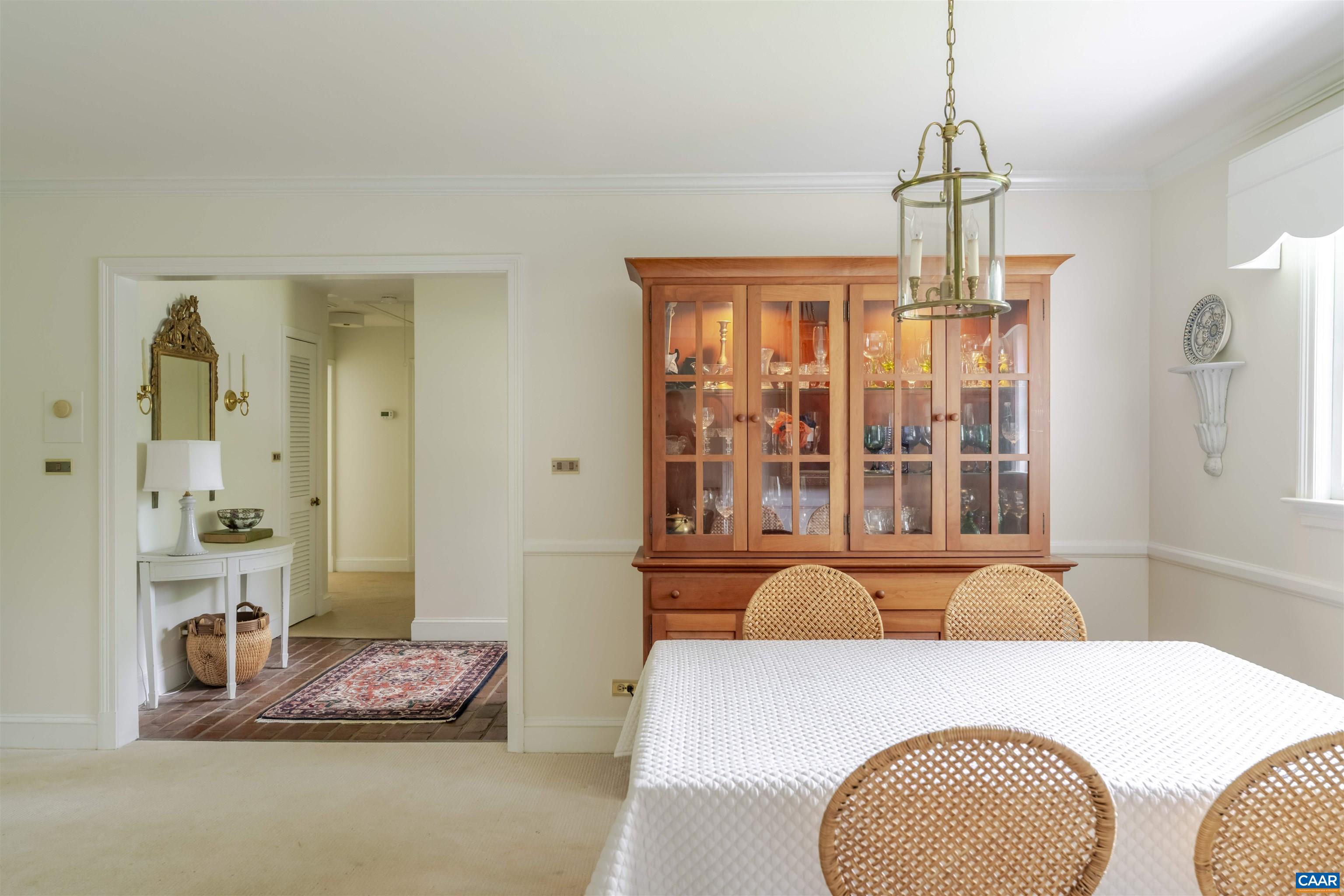 2904 Brookmere Road Charlottesville, VA 22901 - Photo 8 of 20 a bedroom with a bed a chandelier and dresser
