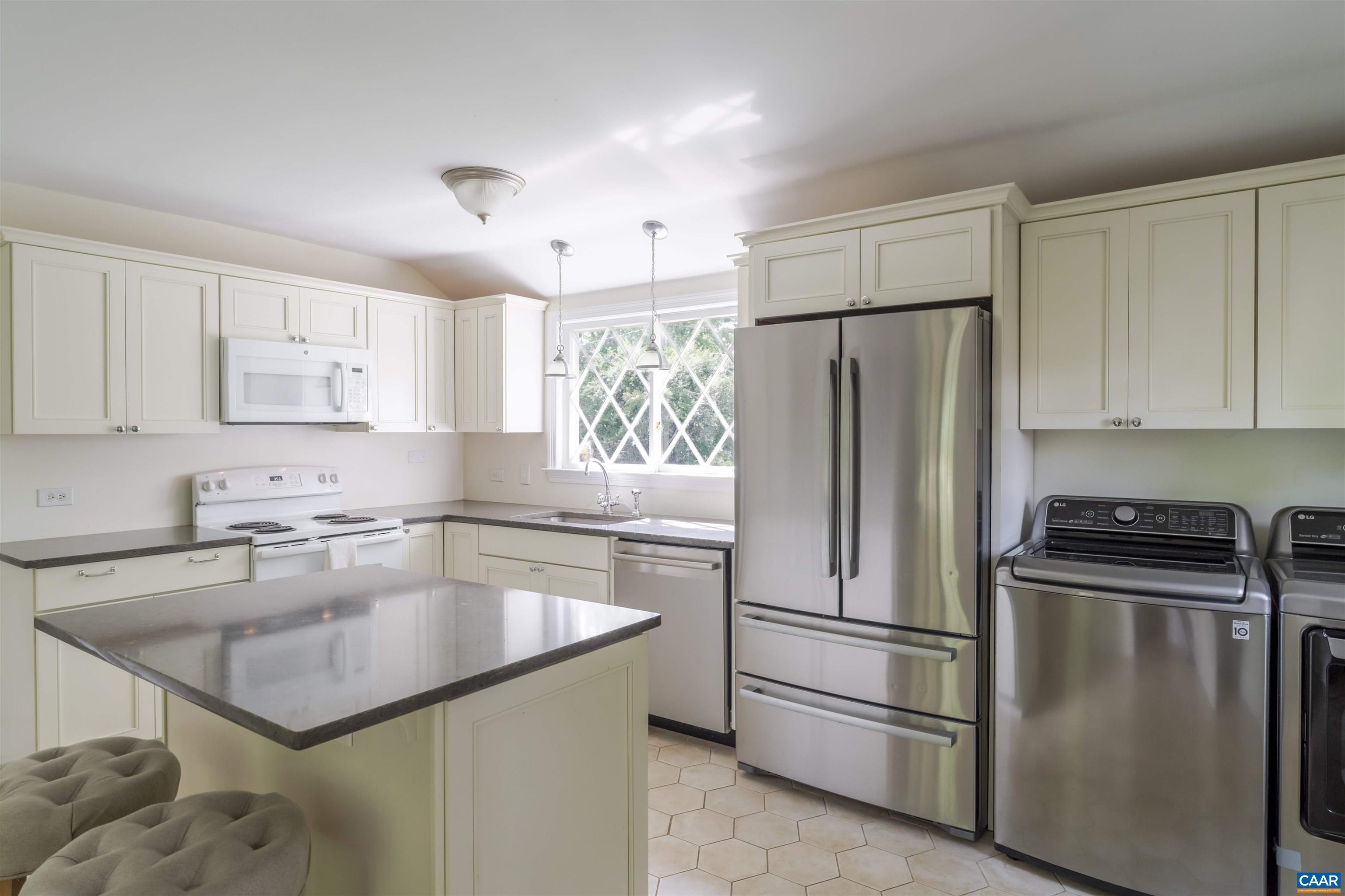 2904 Brookmere Road Charlottesville, VA 22901 - Photo 10 of 20 a kitchen with stainless steel appliances granite countertop a refrigerator a sink a stove a microwave and cabinets