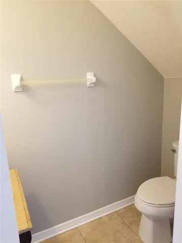 a bathroom with a white toilet and a shower