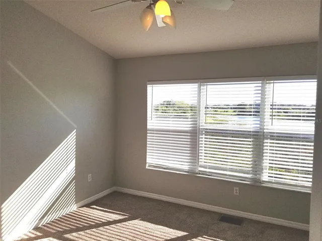 a view of a hallway with closet and a livingroom view
