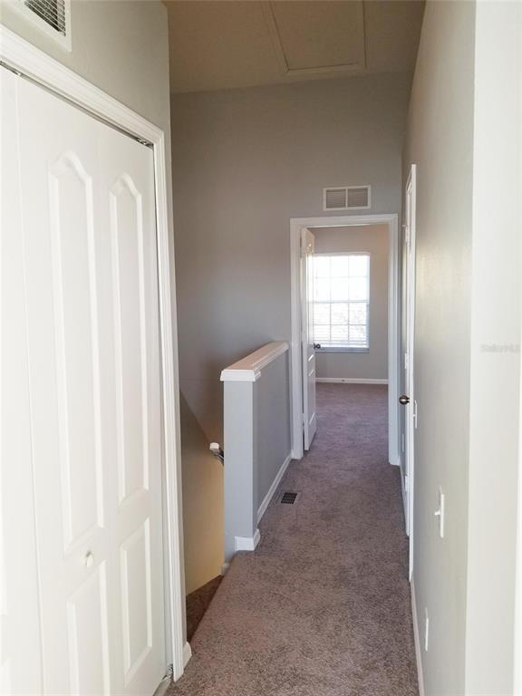 4536 Kennewick Place Riverview, FL 33578 - Photo 30 of 50 a view of a hallway with wooden shelves
