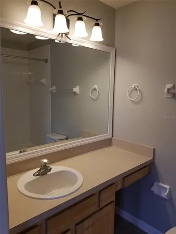 a white toilet sitting next to a bath tub