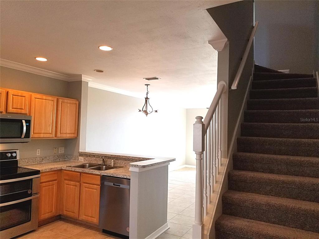 4536 Kennewick Place Riverview, FL 33578 - Photo 10 of 50 a kitchen with granite countertop a stove and a refrigerator