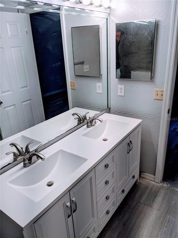 5327 Baldock Avenue Spring Hill, FL 34608 - Photo 7 of 18 a bathroom with a sink and a mirror