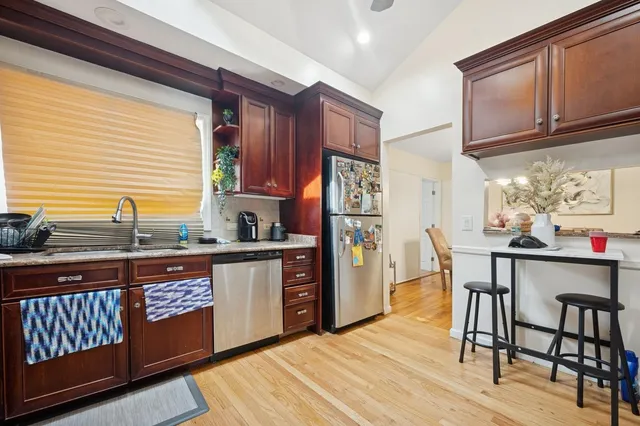 a kitchen with stainless steel appliances granite countertop a refrigerator stove and sink