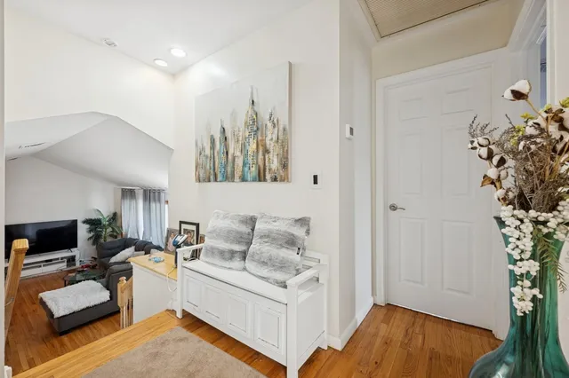 a large bedroom with a bed and wooden floor