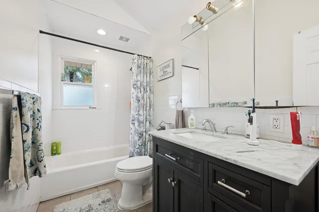 a view of backyard from deck having patio