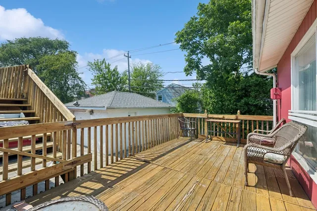 a view of house with deck outdoor seating and city view