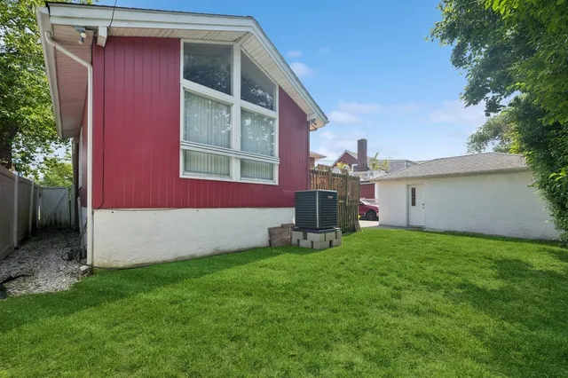 a view of a house with a yard and deck