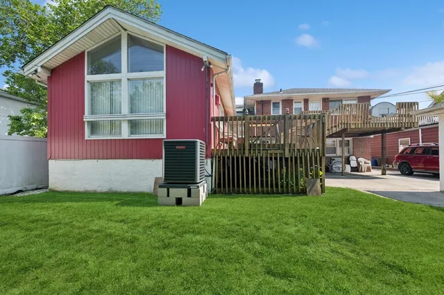 a view of a house with a yard and deck