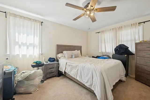 a bathroom with a granite countertop sink and a toilet