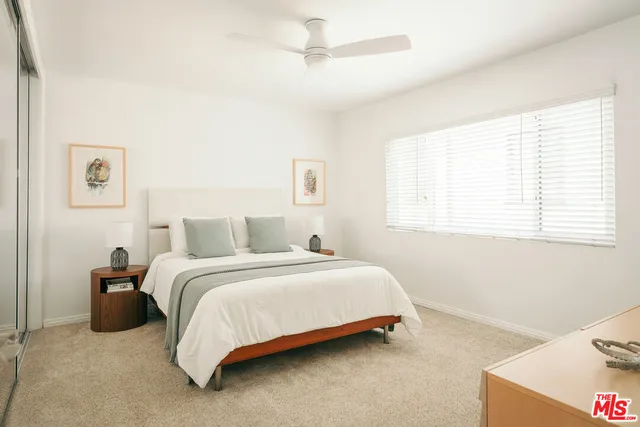 a bedroom with a bed and a dresser