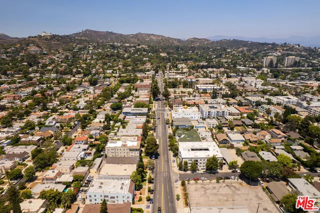 an aerial view of residential houses with city view