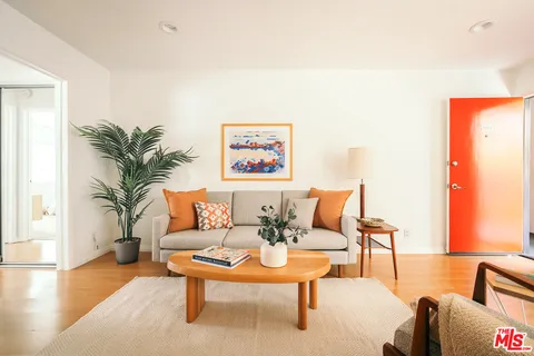 a living room with furniture and a potted plant