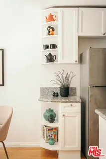 a kitchen with stainless steel appliances a white refrigerator stove and a more cabinets