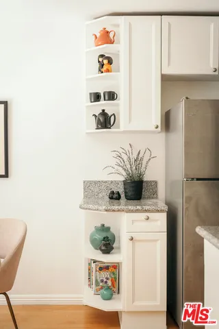 a kitchen with stainless steel appliances a white refrigerator stove and a more cabinets