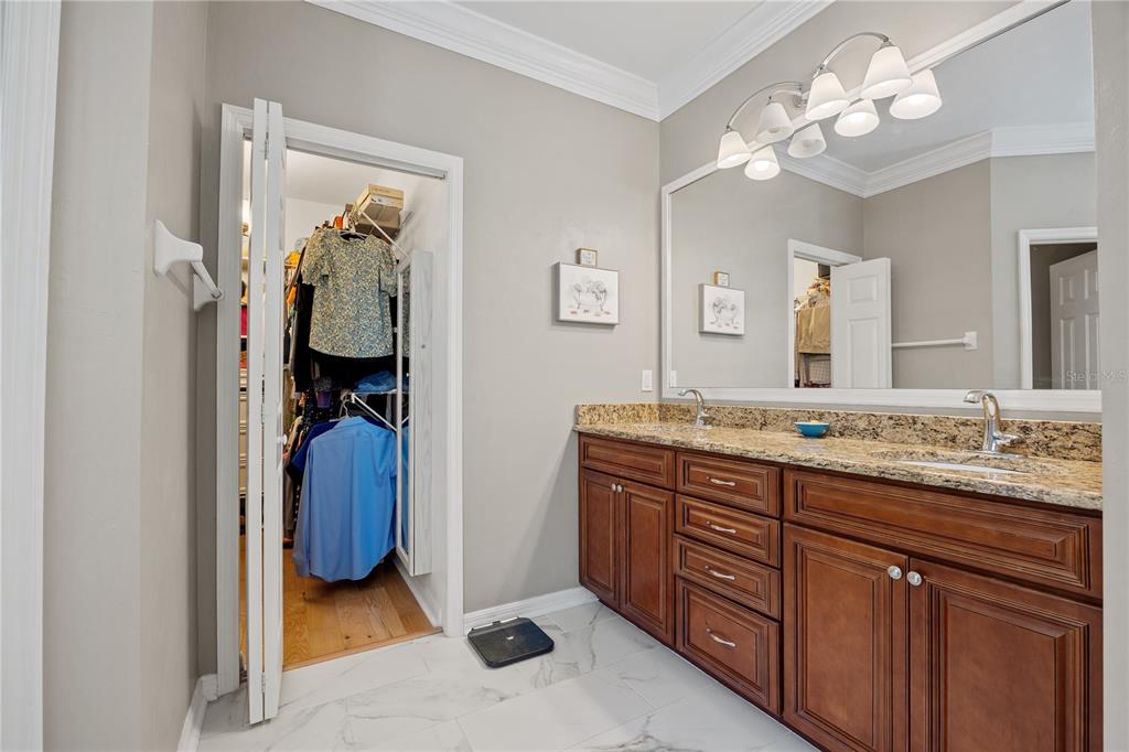 8267 Southwest 78th Lane Gainesville, FL 32608 - Photo 15 of 57 a en suite bathroom with a granite countertop sink and a mirror