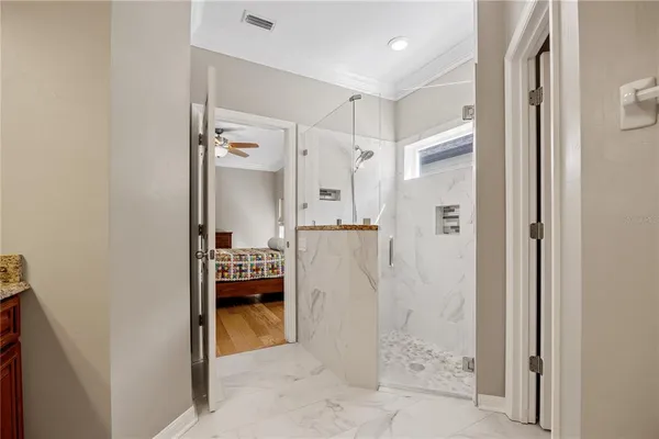 a bathroom with a shower and mirror