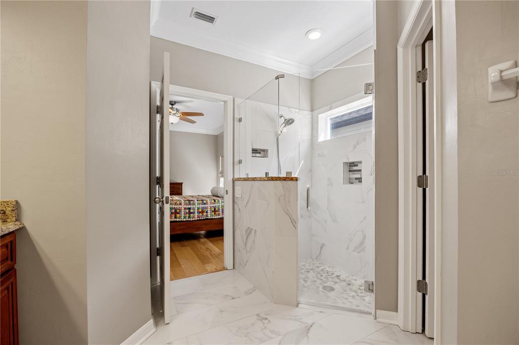 8267 Southwest 78th Lane Gainesville, FL 32608 - Photo 16 of 57 a bedroom with a bed and a view of bathroom