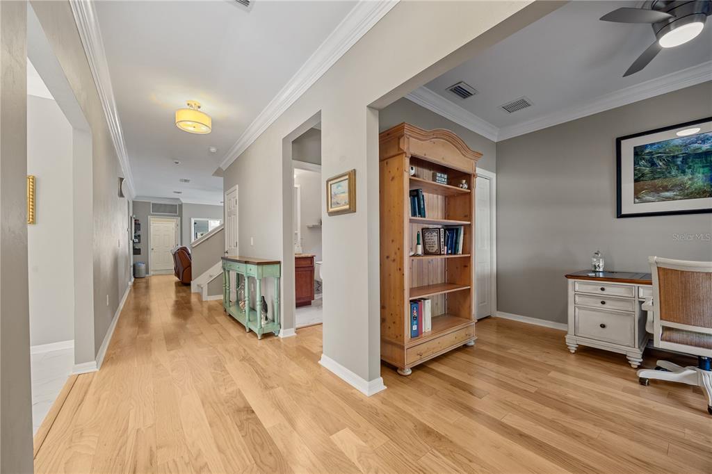 8267 Southwest 78th Lane Gainesville, FL 32608 - Photo 2 of 57 a view of a hallway with workspace and bedroom with windows