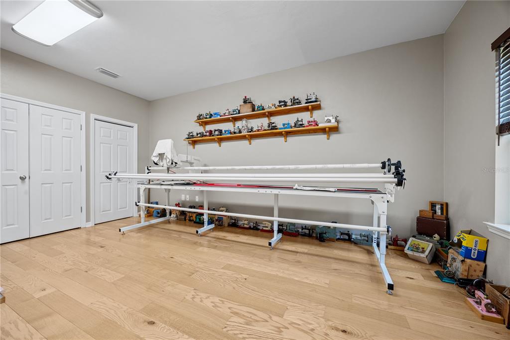 8267 Southwest 78th Lane Gainesville, FL 32608 - Photo 22 of 57 a bedroom with a bed and a chair in it