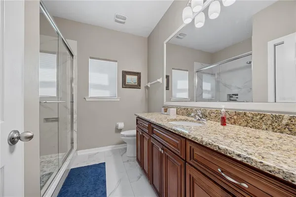 a bathroom with a shower and toilet