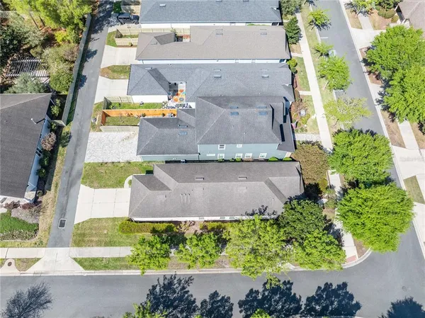 an aerial view of residential houses with outdoor space and street view