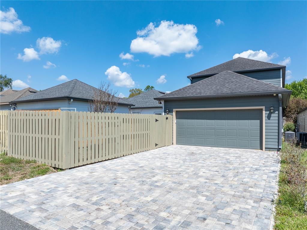 8267 Southwest 78th Lane Gainesville, FL 32608 - Photo 40 of 57 a front view of a house with a yard and garage