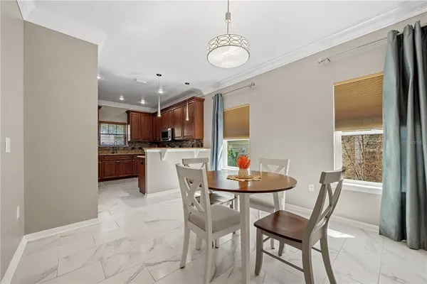 a dining room with furniture and window